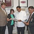 Mississippi State University Extension Service Director Gary Jackson and Oktibbeha County Extension Coordinator Julie White review some of the many publications available through Extension with Edilberto DeLuna and Asterio Saliot, members of an agricultural delegation from the Philippines, visiting the county office on May 28, 2013. (Photo by MSU Ag Communications/Kat Lawrence)