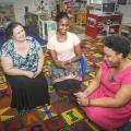 Mississippi State University faculty Lori Elmore-Staton and MSU Extension Service family life specialist Cassandra Kirkland discuss sleep strategies with Santee Ezell of Starkville at a family health workshop hosted by the Brickfire Project. (Photo by MSU Ag Communications/Scott Corey)