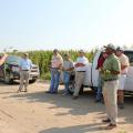 Trent Irby, left, demonstrated how to determine the maturity level of soybeans Aug. 30, 2013, at Mississippi State University's Delta Research and Extension Center in Stoneville. Producers can conserve water and save money on irrigation by correctly timing termination. (Photo by MSU Ag Communications/Bonnie Coblentz)