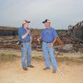 Mississippi State University Extension Service poultry specialist Tom Tabler, left, visits with Winston County poultry grower Tim Hobby on May 8, 2014. Hobby lost 10 broiler houses in the April 28 tornado. (Photo by MSU Ag Communications/Linda Breazeale)