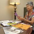 Linda McGrath, a board-certified lactation consultant and La Leche League leader, adds National Breastfeeding Month campaign materials to the nursing mothers' room on the first floor of the Bost Extension Center at Mississippi State University on Aug. 12, 2014. (Photo by MSU Ag Communications/Kevin Hudson)