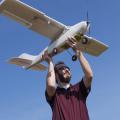 Lee Hathcock, a researcher and doctoral student at Mississippi State University, launches a Robota Triton unmanned aerial vehicle. (Photo by MSU Media Affairs/Beth Wynn)