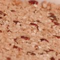 A close-up of honey-cranberry granola bars that shows in fine detail the oats and cranberries.