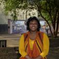 Shandrea Jenkins sitting on a brick planter.