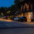 Downtown lights shining along the sidewalk.