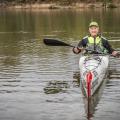 A woman kayaking on the water.