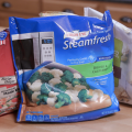 Three bags of frozen food sit on a counter.