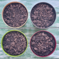 Four pots of soil on a blue background.