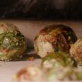 Close-up of roasted Brussels sprouts coated with Panko breadcrumbs on a sheet pan covered with parchment paper. 