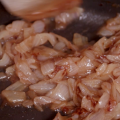 Caramelized onions in a black cast iron skillet.