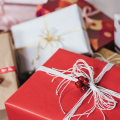 A pile of gifts wrapped in various papers and ribbons.