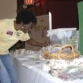 Warren County Master Gardener Yolanda Horne checks on worms living in a plastic bin on June 13, 2017. The worms were part of an exhibit on composting at the Know Your Roots: Grow Your Business workshop in Vicksburg, Mississippi. (Photo by MSU Extension Service/Bonnie Coblentz)