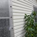 A clear panel covers a window on the exterior of a house.