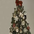 A Christmas tree is hung with red and white ornaments.