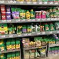 Bottles and bags fill a row of shelves in a store.
