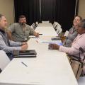 Four people at a table talking to each other.