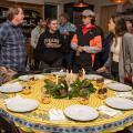 A group gathers around a decorated table.