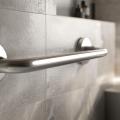 Closeup of stainless steel safety grab bar in a bathroom.