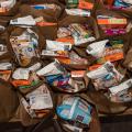 An assortment of food items inside paper grocery bags