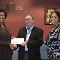 Sandra Jackson, left, a Mississippi State University Extension Service program associate, accepts a check from Dave Billington, Sitel Starkville site director, on behalf of Sitel’s employee recognition program. Stella Jackson, right, Sitel’s 2012 International Customer Management Institute Supervisor of the Year, chose to support the Winston County 4-H Youth Development program through Sitel’s recognition program because of the positive impact it has on local youth. (Photo by MSU Ag Communications/Kat Lawre