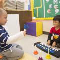 These two preschoolers play their first musical instruments in the Child Development and Family Studies Center at Mississippi State University. (School of Human Sciences file photo/Alicia Barnes)