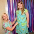 Mississippi State University fashion design and merchandising major Kelsie Bynum of Laurel inspects the dress she constructed for Oktibbeha County 4-H member Cassin Gant before a special fashion show in Starkville, Mississippi, on May 2, 2015. (Photo by MSU Ag Communications/Linda Breazeale)