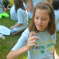 Adara Blalock, 10, visits with a grasshopper (or vice versa) while taking a break during the Adams County Farm Camp near Natchez, Mississippi, on July 7, 2016. (Photo by MSU Extension Service/Linda Breazeale)