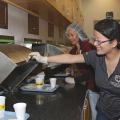 Doctoral student Yan Campbell, front, and research associate Vi Jackson serve trays to consumer panelists, who evaluate the food samples and determine how acceptable they are. (Photo by MSU Extension Service/Kat Lawrence)