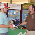 Parker Simpson of Choctaw County, left, talks with all-terrain vehicle safety instructor Brad Staton about the proper gear to wear while riding an ATV, including a helmet, eye protection and gloves. (Photo by MSU Ag Communications/Keri Collins Lewis)