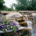 Blue Wave petunia, Aztec Silver Magic verbena and AngelMist Purple Stripe angelonia make for a great combination planting to complement this spectacular water feature.