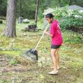 Andrea Brown, a 14-year-old Oktibbeha County 4-H member, rakes limbs and debris in the yard of a senior adult friend in the Bell Schoolhouse Community. Many Mississippians are depending on the help of friends and family to assist in cleaning up in the wake of Hurricane Katrina.