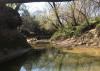 A shallow creek between two hills.