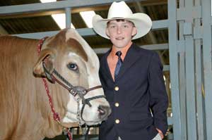 A 4-H member with his steer.