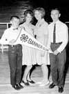 This image shows young people holding a 4-H banner.